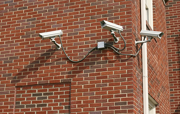 <img src="SecurityCamerasPS.jpg" alt="three security cameras attached to brick wall">