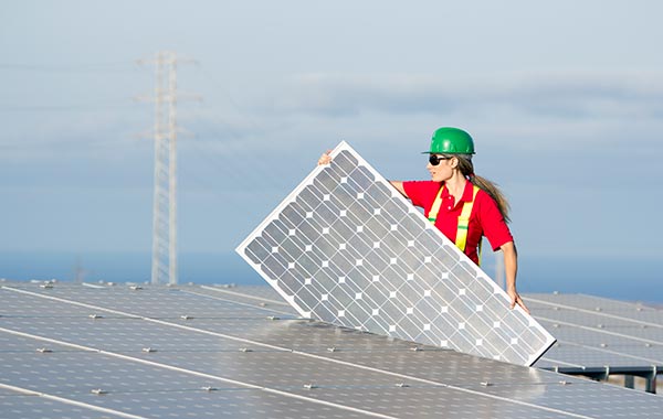 Female contractor installing solar panel